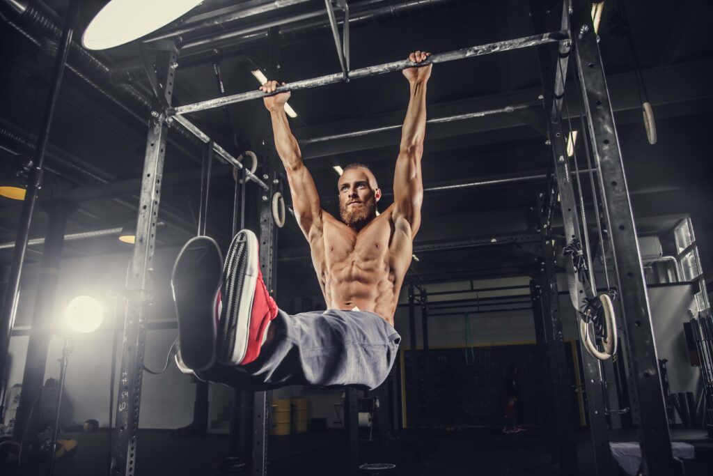A man doing stomach exercises on a horizontal bar