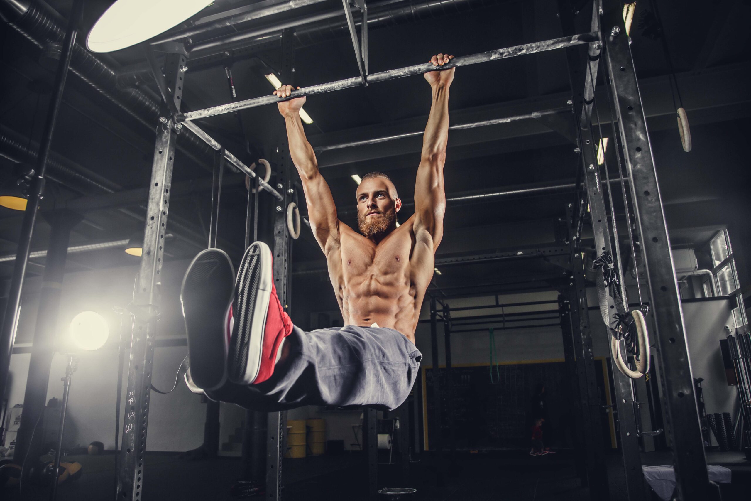 A man doing stomach exercises on a horizontal bar